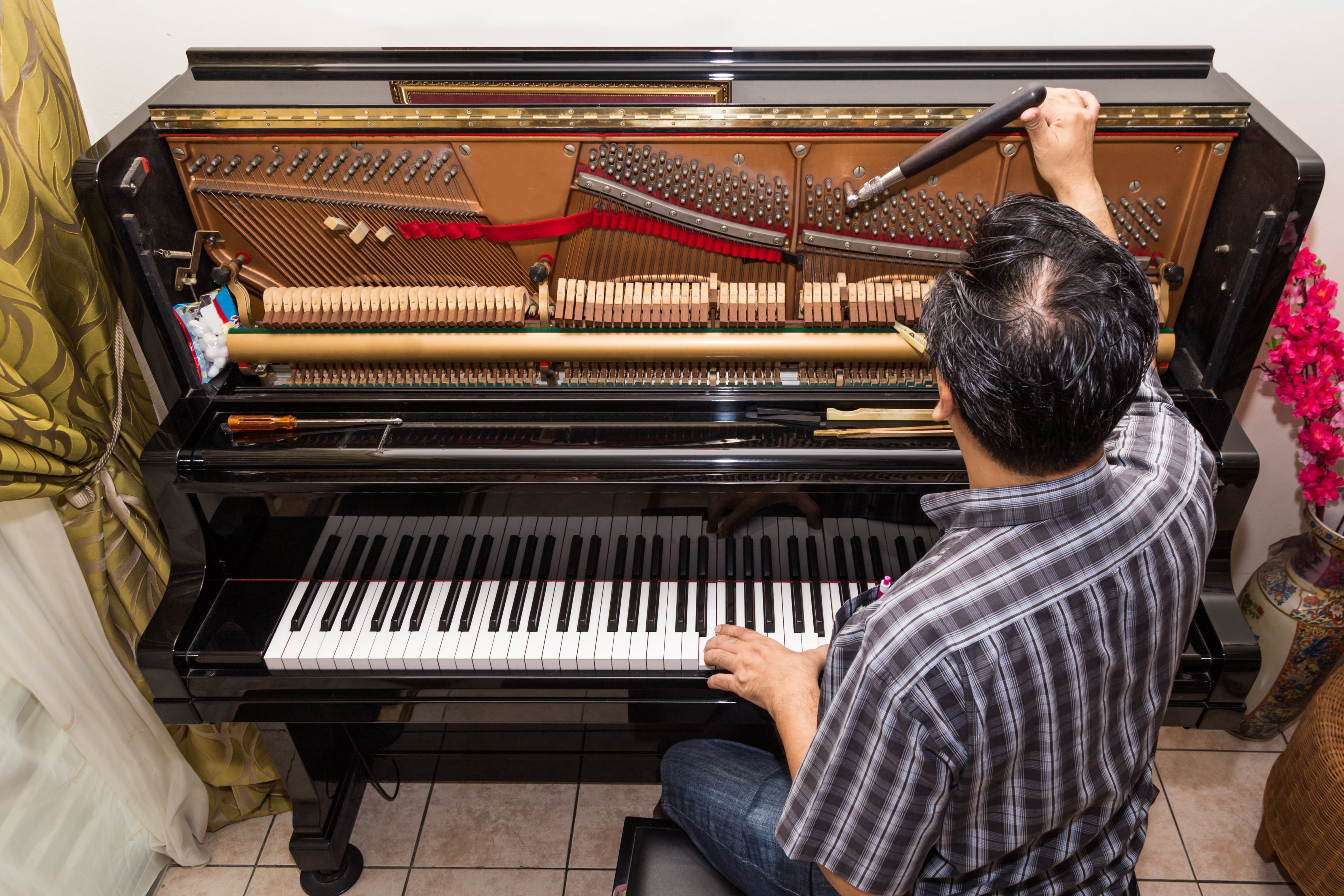 man tuning the piano